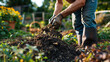 Man turning organic compost pile in a vibrant community garden