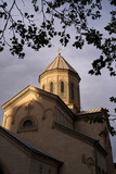 Fototapeta  - The Kashveti Church of St. George in central Tbilisi, located across from the Parliament building on Rustaveli Avenue. Dramatic light on dark clouds background.
