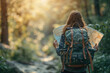 © Александр Марченко - A female explorer with a backpack and a map walks through the forest