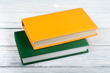 Canvas Print - Multi-colored books on a white wooden table. Copy space for text.
