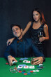 Happy winning poker player  with poker cards and chips in casino.