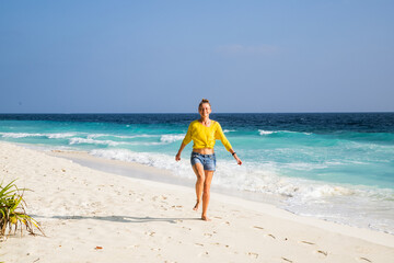 Wall Mural - beautiful woman having fun on a tropical beach