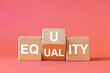 equality and equity concept. Human rights, equal opportunities and appropriate needs. Changing word on wooden block, Equality or equity symbol. Beautiful pastel pink background, copy space