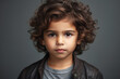 Portrait of a charming boy with black curly hair