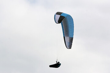 Poster - Paraglider flying in a cloudy sky