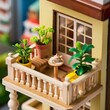Miniature toy doll house neat cozy white balcony with table with teapot and garden, plants, flowers in pots