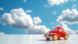 Fototapeta Kwiaty - Czerwony samochód zabawkowy stoi na białym stole. Obrazek przedstawia scenę z Dnia Dziecka. Perspektywa z punktu widzenia dziecka