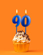 Blue candle number 90 - Birthday cupcake on orange background