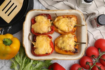 Wall Mural - Delicious stuffed bell peppers served on white textured table, flat lay