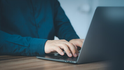 Poster - Entrepreneur use laptop working in home office. Man typing on laptop computer keyboard. Business and technology concept of entrepreneur work, work from home, businessman working at home office.