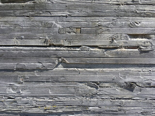 Wall Mural - Section of an old massive gray building wall made of wood planks