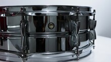 Steel Snare Drum Close Up Panning Against White Background