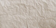 Brown crumpled paper background. Vector texture of crumpled paper. Background paper. Textured wallpaper. Crumpled paper design