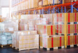 Package Boxes Wrapped Plastic Stacked on Pallets in Warehouse.  Tall Shelve Storage Warehouse. Supply Chain, Supplies Shipment. Warehouse Shipping Logistics.