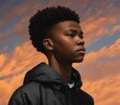 Young African American boy wearing a black jacket during a sunset