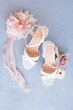 Elegant white wedding heels with pastel floral arrangement on so