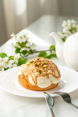 Wall Mural - Cinnamon roll bun with icing on plate