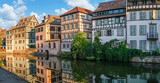 Fototapeta Lawenda - Le Petite France, the most picturesque district of old Strasbourg. Half-timbered houses with reflection in waters of the Ill channels.