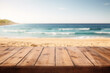 Empty wooden table with with blurry beach and ocean in background