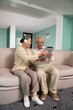 © Best View Stock - Elderly couples use tablet computers in the living room