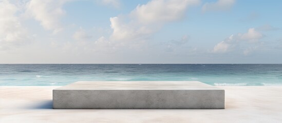 Wall Mural - Front view of a grungy grey concrete stone platform podium for cosmetics or products set against a white beach sand background with copy space image