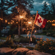 Canadian flag and sparklers placed on a rock outdoors Canada day