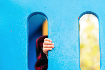 Wall Mural - baby hand holding a gate of a playground