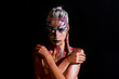 Art nude Portrait of young woman with art make-up. The Body Art. Abstract face paint. Sexy Model with creative art makeup. Creative body paint and hairdo. Woman in paint. Attractive female Face draw.