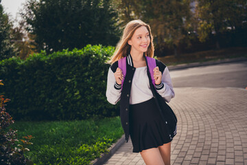 Poster - Photo of pretty cute girl wear school uniform mini skirt rucksack enjoying sunny day walking college outside urban city park