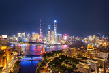 Fototapeta  - Shanghai Skyline Illuminated at Night with Vibrant Lights