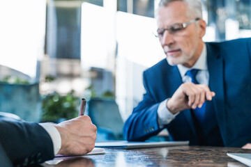 Businessman signing contract investment professional document agreement, senior man in suit with company contract. Adult senior salesmen are letting the male customers partner sign the sales