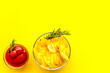 Potato chips served wiith ketchup on yellow background top view mock up
