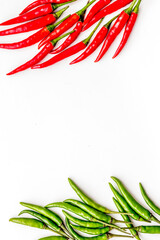 Wall Mural - Fresh red and green chilli pepper pattern on white table background top view mockup