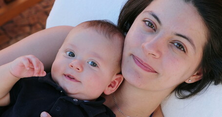 Wall Mural - Portrait of mother and baby son faces looking to camera