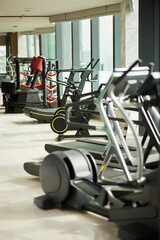 Modern Fitness Center- Bright, spacious gym with cardio machines and natural light