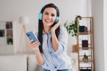 Sticker - Portrait of pretty lady hold phone touch headphones wear shirt bright interior apartment indoors