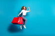 Photo portrait of nice young lady hold shopping bags running wear trendy white garment isolated on blue color background