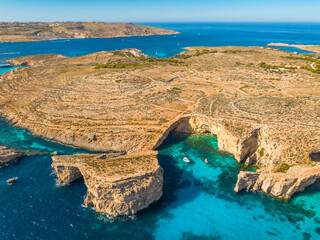 Wall Mural - Aerial drone view of Crystal lagoon on Comino island. Boats. Mediterranean sea, Malta island