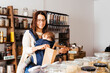 Mother With Baby Shopping for Sustainable Goods at a Zero-Waste Grocery Store