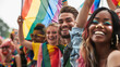 © Patarapoom - group of diverse lgbtq friends wearing colorful clothes, standing side by side, smiling and holding lgbt flags waving in the air, support of lgbt community equality movement and lgbt happy pride month