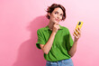 © deagreez - Photo of cute dreamy young woman dressed green shirt arm chin reading modern gadget empty space isolated pink color background
