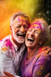 Senior couple with colorful faces enjoying Holi festival