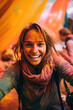 Excited woman covered in Holi powder with joyful expression