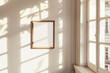 Elegant wooden frame mockup hanging on a sunny wall