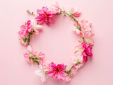 Fototapeta  - Wreath made of pink flowers on pink background. Flat lay, top view, copy space