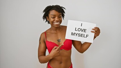 Poster - Cheerful young black woman with dreadlocks confidently pointing and smiling at 'i love my body' text she's presenting, optimistically marking an idea of self-love on isolated white background.