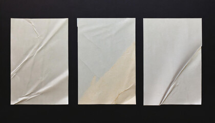 Wall Mural - white crumpled and creased glued paper poster set isolated on black background