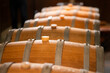 Old wooden wine barrels stacked in a cellar in order