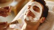 © HelenP - A Man Receiving Facial Spa Treatment