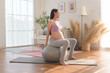 Healthy pregnant woman exercising and doing prenatal yoga, meditation, working out, yoga, pregnancy concept.